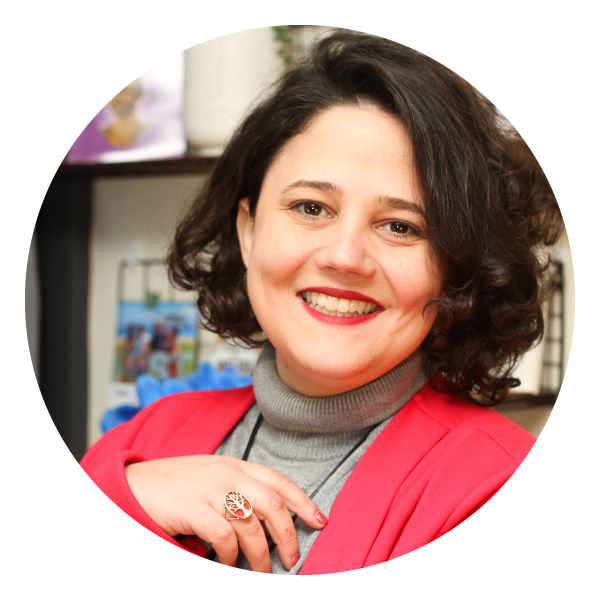 Smiling dark haired woman wearing red blazer