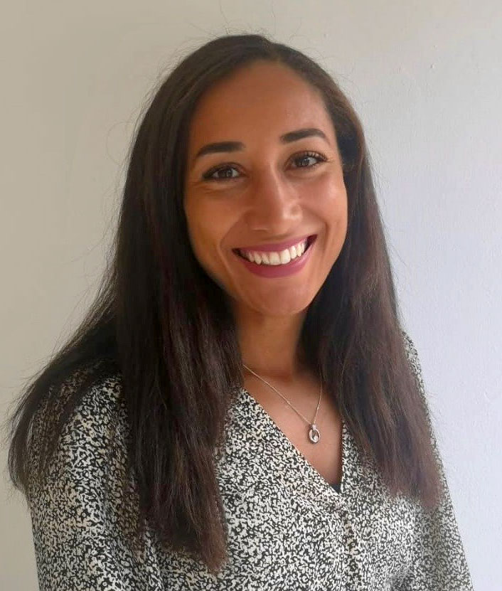 Photo of smiling woman with long dark hair and dark eyes